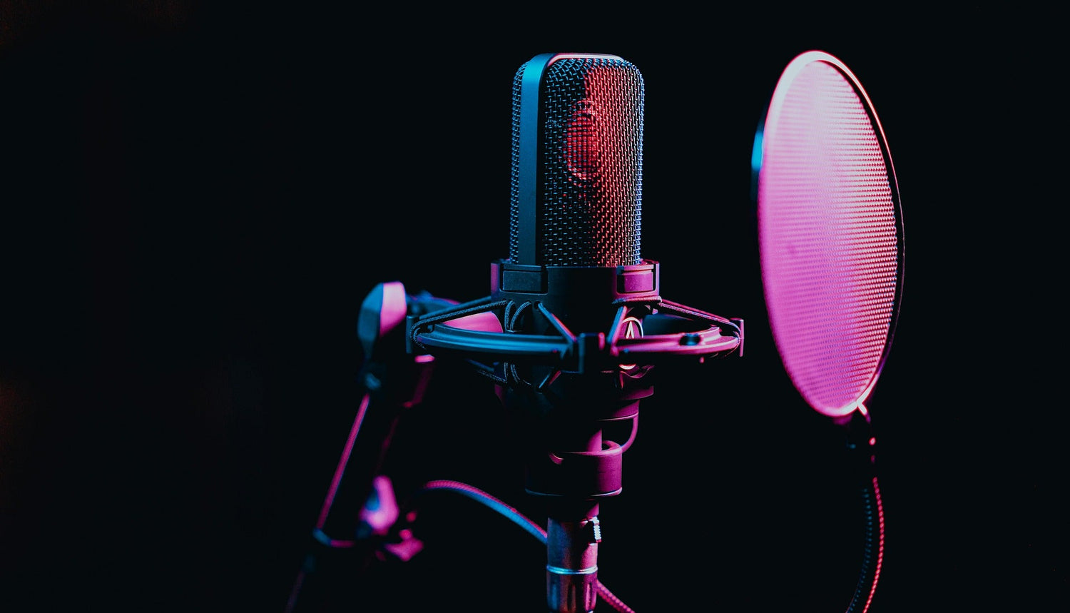 Microphone with a pop filter on a dark background